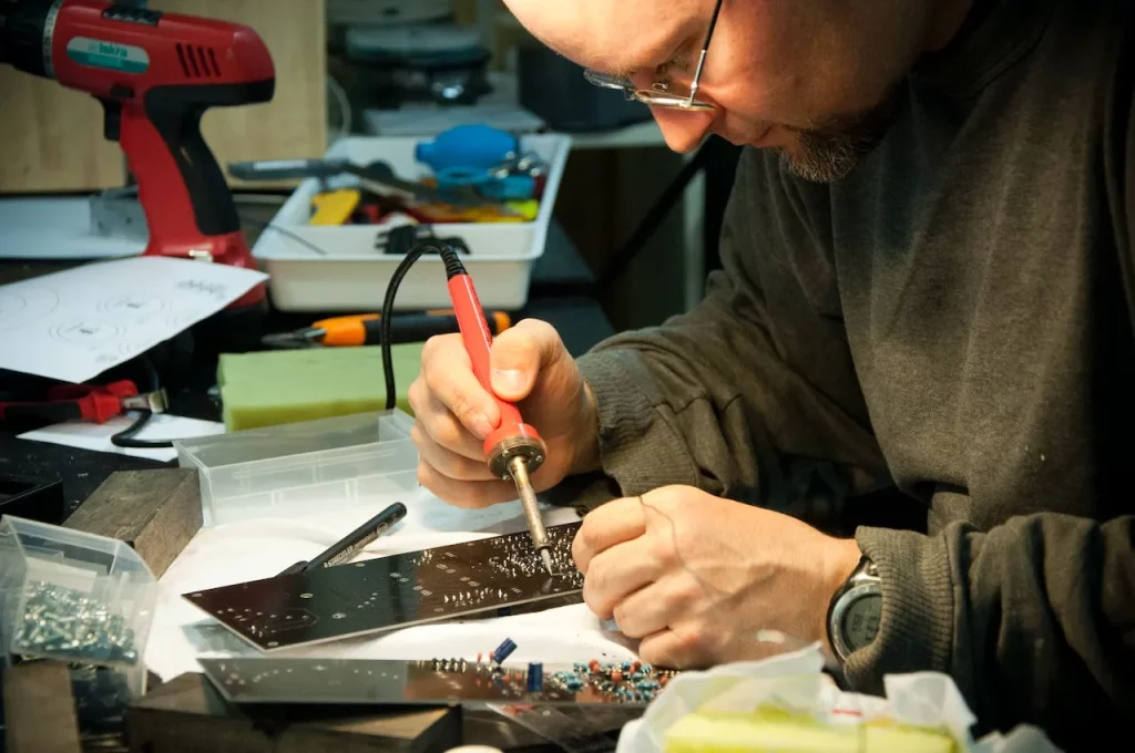 remove solder from a circuit board using a soldering iron
