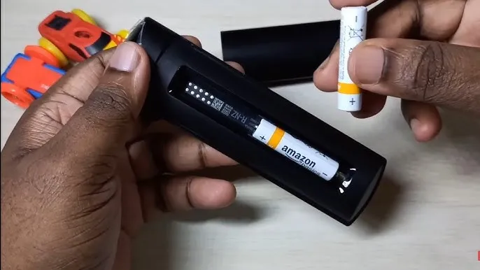Person inserting new batteries into an Onn TV remote.