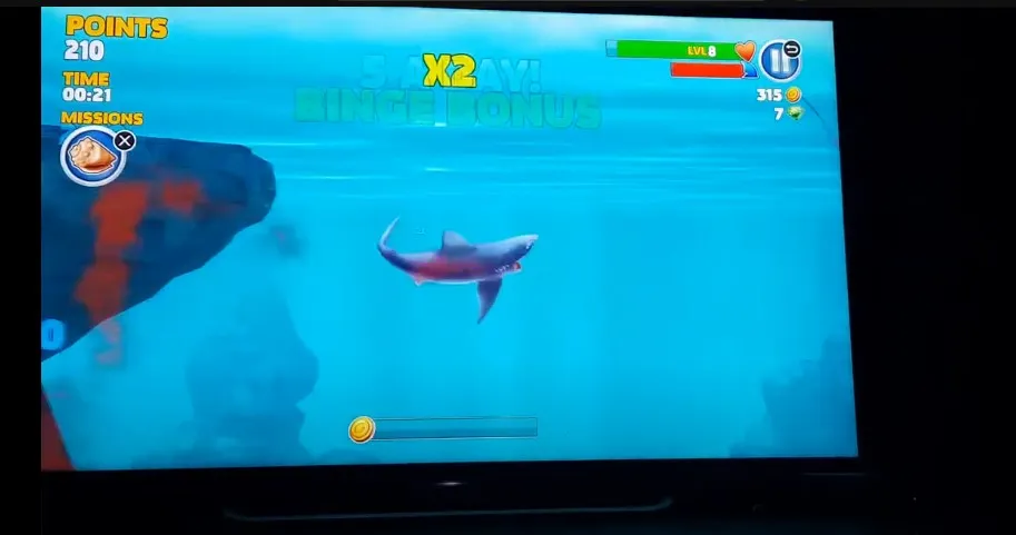 A shark eating fish in Hungry Shark Evolution