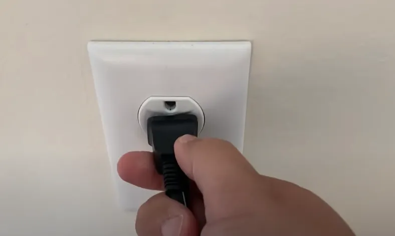 Person unplugging Vizio TV for power cycle