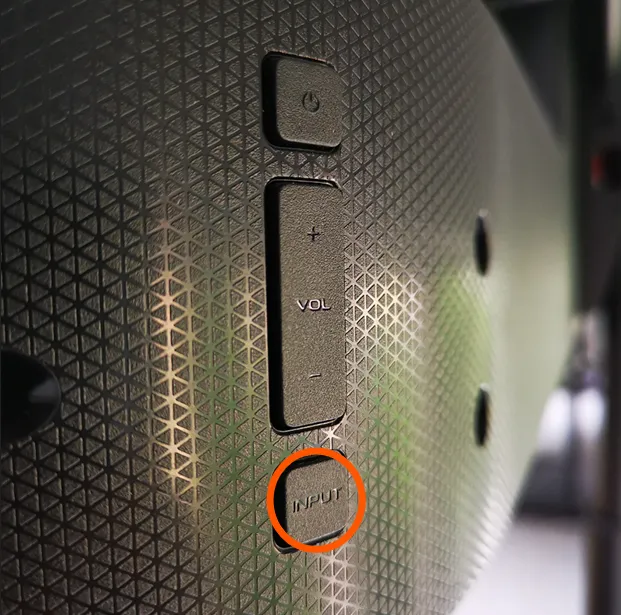 Vizio TV back panel with Input button highlighted.